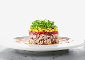 Rice timbale with tomatoes, corn and sprouts