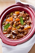 Beef stew being made in a slow cooker