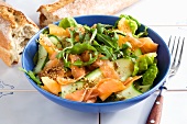 Salmon salad with cucumber, lettuce and melon