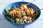 Salmon kebabs on a bed of tabbouleh