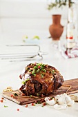 Leg of lamb with garlic, herbs and pomegranate seeds
