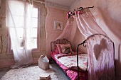 Romantic pink bedroom with wrought iron bed