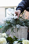 Flower arrangement in white basket