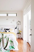 Double bed and birch-log side table in bedroom