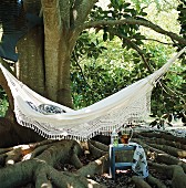 Hammock and side table beneath shady tree