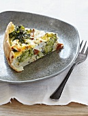 A slice of broccoli quiche with dried tomatoes