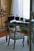 Vintage writing desk with original paintwork and wooden chair with patchwork-style upholstered seat