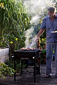 A man barbecuing on a terrace