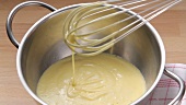 Hollandaise sauce in a mixing bowl