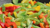 Colourful pepper strips being fried