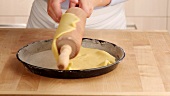 Pastry being placed in a quiche dish