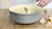 Croutons being dipped into a cheese fondue