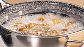 Unpeeled potatoes being boiled in sea salt