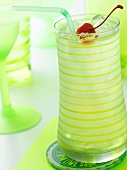 Tom Collins in a Green Striped Glass with a Straw, Ice and Maraschino Cherry