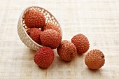 Lychees falling out of a bowl