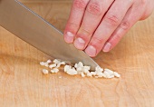 Garlic being finely chopped