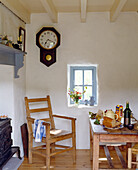 Rustic dining area with wooden furniture and vintage wall clock