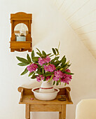 Wooden side table with wash bowl and rhododendron flowers