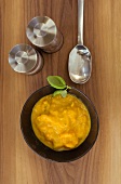 Pumpkin soup with basil with salt and pepper mills