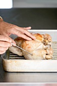 Temperature of roast chicken being taken
