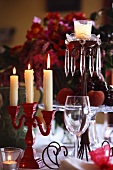 A Christmas table with various candle sticks