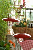 Tealight holders with red metal lids as decoration in cottage garden