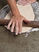 Pizza dough being rolled out