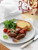 Sausages with tomatoes and garlic bread