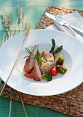 Rabbit fillet wrapped in ham and barley risotto