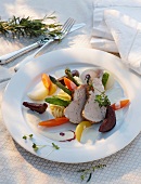 Veal on a bed of vegetables with a wine sauce