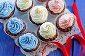 Chocolate cupcakes topped with coloured cream