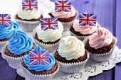 Chocolate cupcakes decorated with coloured cream and Union Jacks