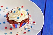 A chocolate cupcake topped with cream