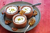 Chocolate creme topped with whipped cream, pistachios and pistachio caramel