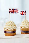 Vanilla cupcakes topped with cream cheese frosting and British flags