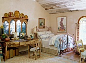 Charming art noveau style bed next to an antique wall table in front of a traditional country home window in the attic bedroom