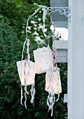 Mobile made of paper-bag lanterns as garden decoration