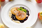 Baked apple slices with plum and elderberry compote