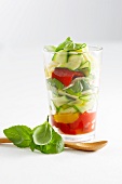 A layered vegetable salad in a glass