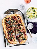 Grape tart with goat's cheese, bacon and chicory salad