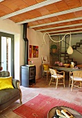 Log burner next to dining table in open-plan living area