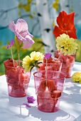 Chunks of watermelon in plastic cups decorated with flowers