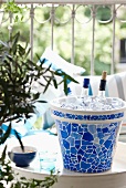 Ceramic pot painted with mosaic tile pattern as home-made ice bucket