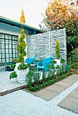 Topiary cypress trees in pots on terrace of house