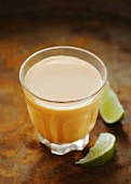 A glass of mango lassi (mango yogurt drink)