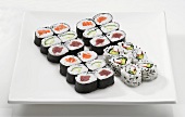 A sushi platter with maki and inside out rolls