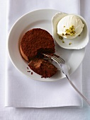 Chocolate cake with ice cream and pistachios with a bite taken out