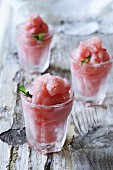 Watermelon granita in glasses on a wooden surface