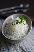 Cooked rice with a sprig of mint