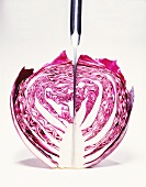 Half of a Head of Purple Cabbage with a Knife in It; White Background